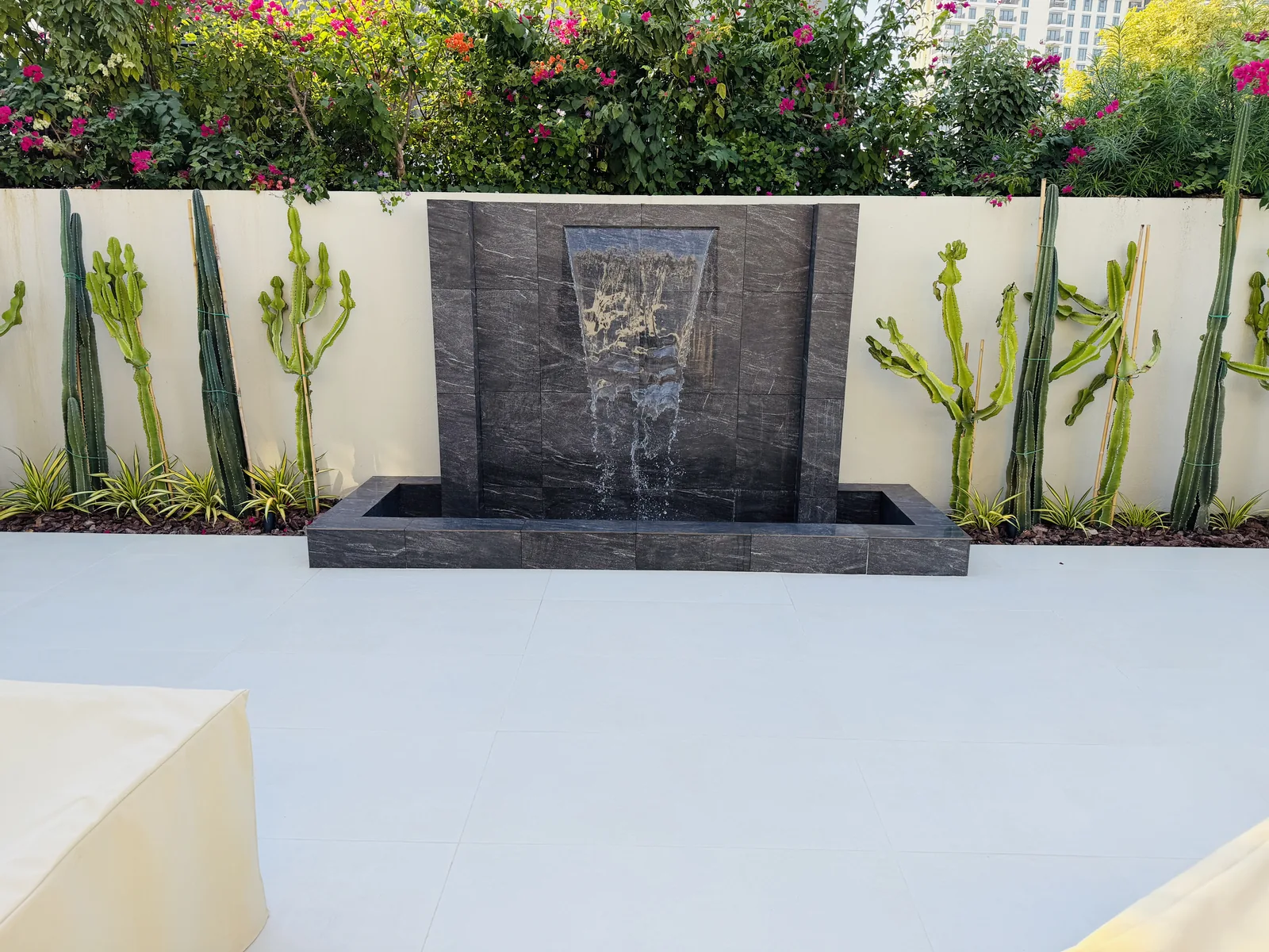 Garden wall water feature with planting and stone details