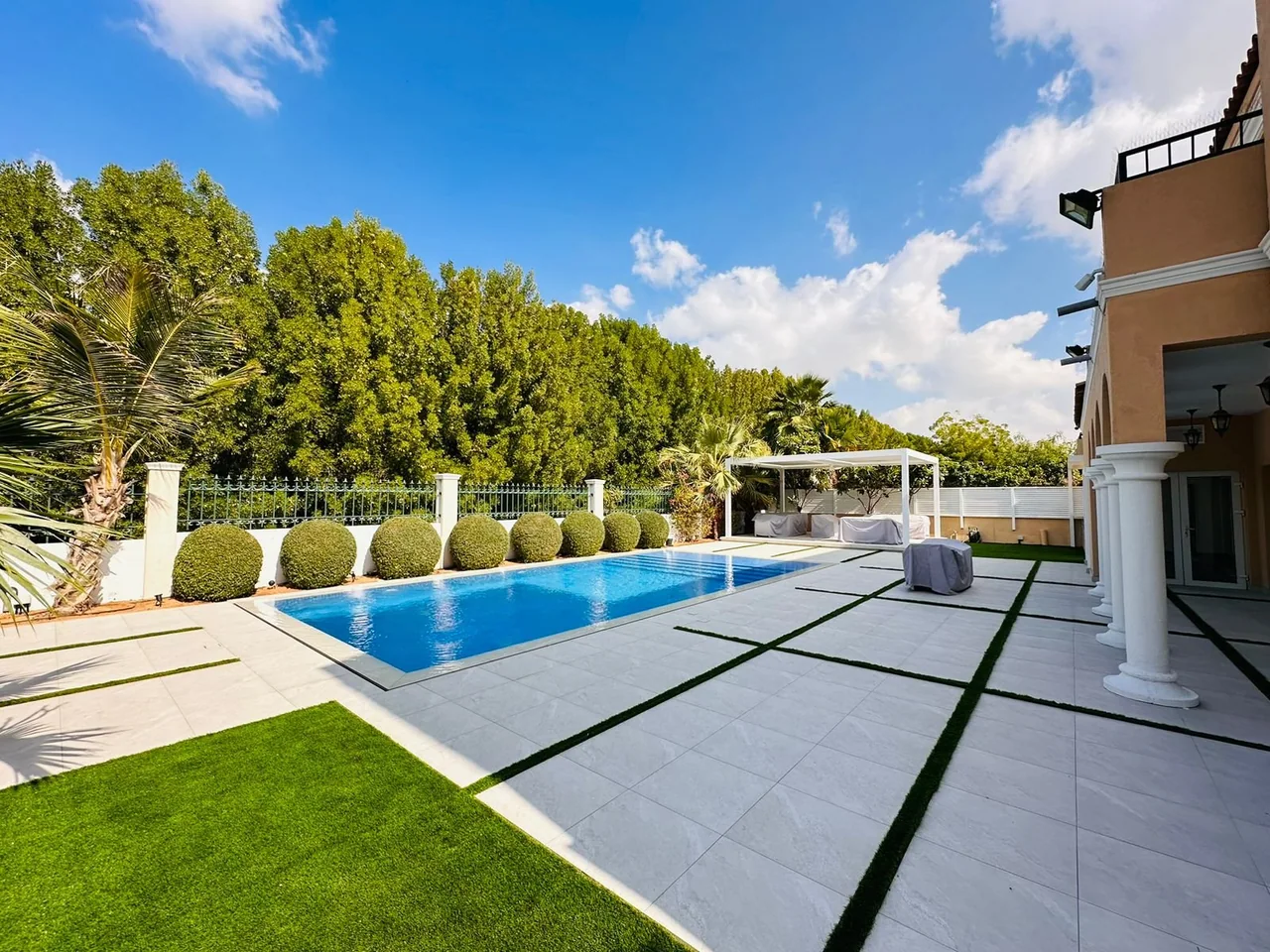 Swimming pool framed by lush green garden planting